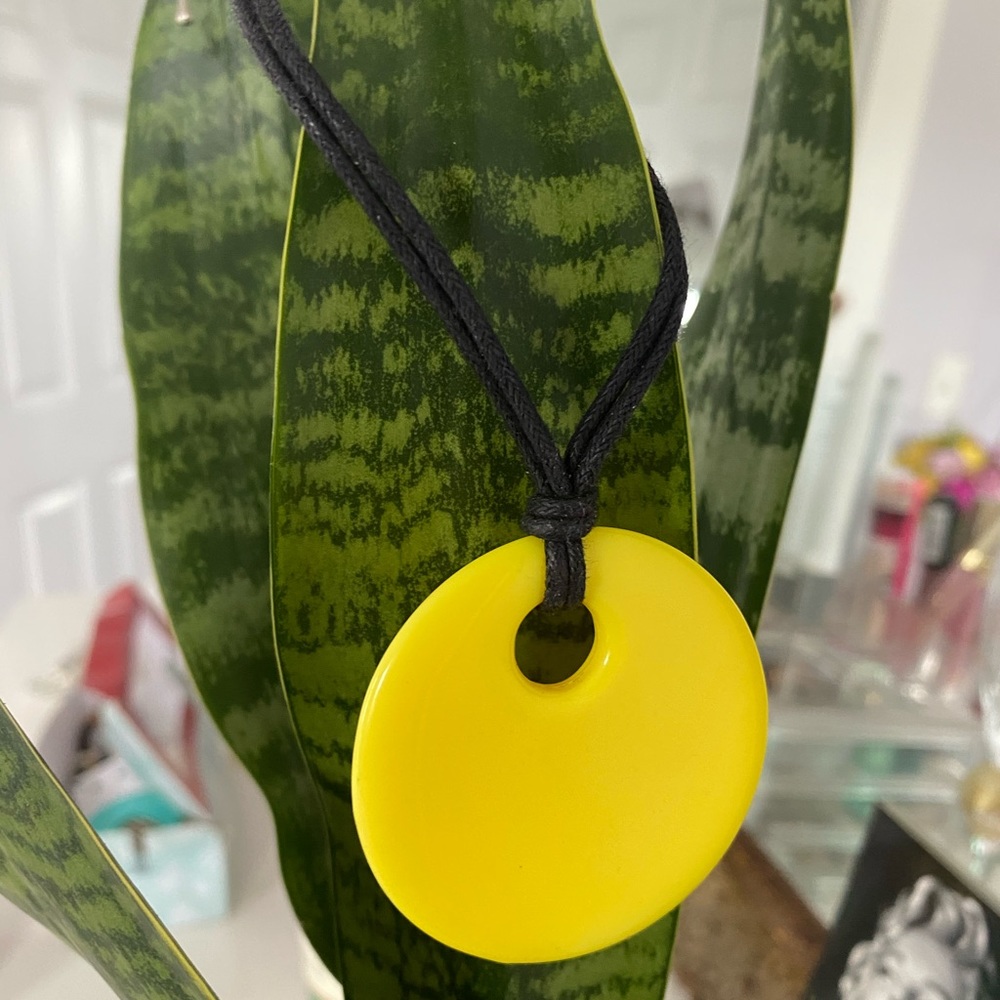 Yellow circular pendant necklace.